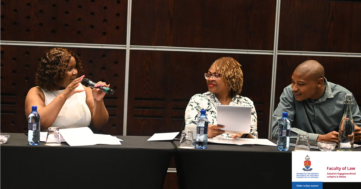 This is a photo of four delegates participating in a group activity. All four delegates are seated in the photo. One of the delegates is holding the microphone and is sharing her reflections, while the other three delegates all appear to be smiling